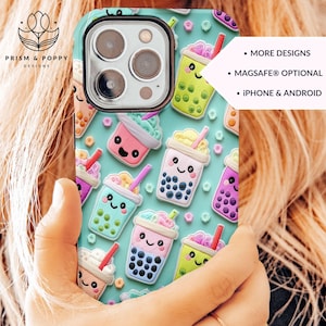 May include: A turquoise phone case with a pattern of colorful boba tea cups with smiling faces. The text "MORE DESIGNS", "MAGSAFE® OPTIONAL", and "IPHONE & ANDROID" is printed on the case.