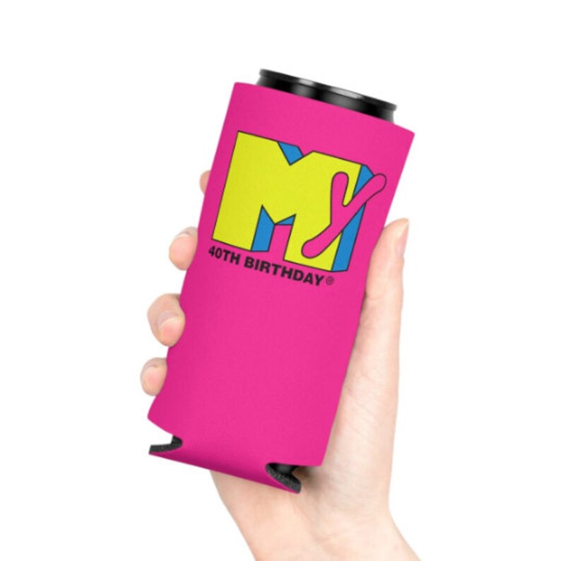 May include: A pink can cooler featuring the MTV logo in yellow, blue, and pink, with the text "40TH BIRTHDAY". The cooler is held in a hand and is designed to keep beverages cold.