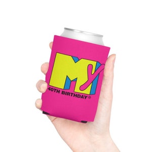 May include: A pink can cooler featuring the MTV logo in yellow, blue, and pink, with "40TH BIRTHDAY" printed below. The can cooler is designed to keep beverages cold and is held in a hand.