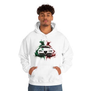 Puede incluir: Sudadera con capucha blanca con un estampado gráfico de un coche blanco con salpicaduras de acuarela verde y roja detrás.