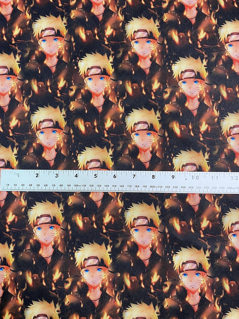 May include: Fabric featuring a repeating pattern of a character with spiky blonde hair, blue eyes, and a black headband. The character is set against a fiery, orange and brown background. The fabric is approximately 12 inches wide.
