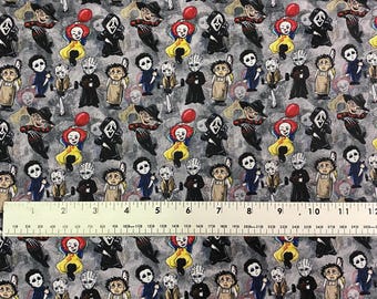 May include: A gray fabric with a repeating pattern of cartoon horror movie characters, including Pennywise, Ghostface, and Freddy Krueger. The design features a ruler with inch measurements.