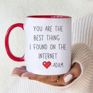 May include: White ceramic mug with a red rim and handle. The mug has the text "You are the best thing I found on the internet -Adam" with a red pixelated heart.