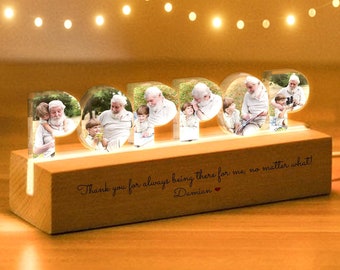 May include: A wooden photo frame with a light-up feature, spelling out the word "POP" with photos of a family inside each letter. The base of the frame has a message that reads "Thank you for always being there for me, no matter what! Damian".