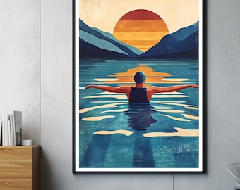 May include: A framed art print depicts a swimmer in a lake with arms outstretched, facing a sunset. The artwork features a color palette of blues, oranges, and yellows, with mountains in the background. The swimmer wears a blue cap and swimsuit.