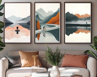 May include: Three framed landscape prints with a mountain range and a body of water reflecting the mountains. The first print shows a person swimming in the water. The second print shows a person riding a bicycle on a road winding through the mountains. The third print shows a person walking along a path in the mountains.