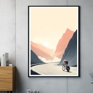 Könnte beinhalten: Gerahmter Kunstdruck mit einem Radfahrer auf einer Bergstraße. Das Kunstwerk verwendet einen minimalistischen Stil mit einer Palette gedämpfter Farben, darunter Pfirsich, Grau und Schwarz. Der Radfahrer ist in Bewegung, was der Szene Dynamik verleiht.