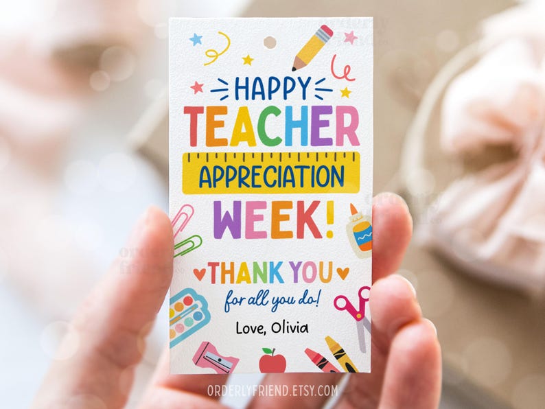 May include: A colorful card with the text "Happy Teacher Appreciation Week!" and "Thank You for all you do!" with a heart on each side of the text. The card also has a ruler, scissors, crayons, a pencil, a paint palette, a glue bottle, and a pencil sharpener. The card is signed "Love, Olivia".