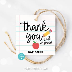 May include: A white gift tag with a red apple and yellow pencil design. The tag says "Thank you for all you do! Love, Sophia".