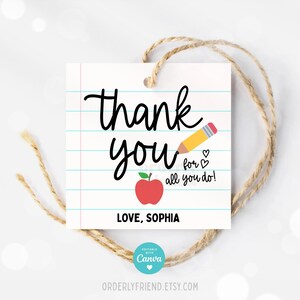 May include: A white gift tag with a red apple and a yellow pencil on a lined background. The text on the tag reads "Thank you for all you do! Love, Sophia".