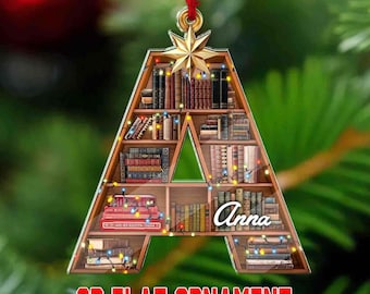 May include: A clear acrylic Christmas ornament shaped like the letter "A", filled with miniature books and a star on top. The ornament has the name "Anna" on it and the text "2D FLAT ORNAMENT ACRYLIC MATERIAL".