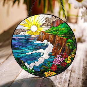 May include: A stained glass window depicting a seascape with a cliff, waves, and flowers. The sun is shining brightly in the sky. The colors are vibrant and the design is intricate.