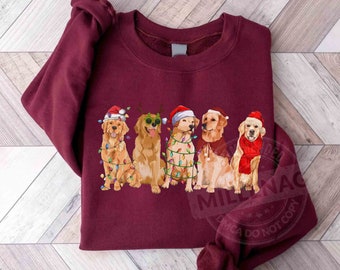 Può includere: Una felpa color borgogna con un design natalizio che presenta cinque golden retriever che indossano cappelli di Babbo Natale e sono avvolti da luci natalizie.