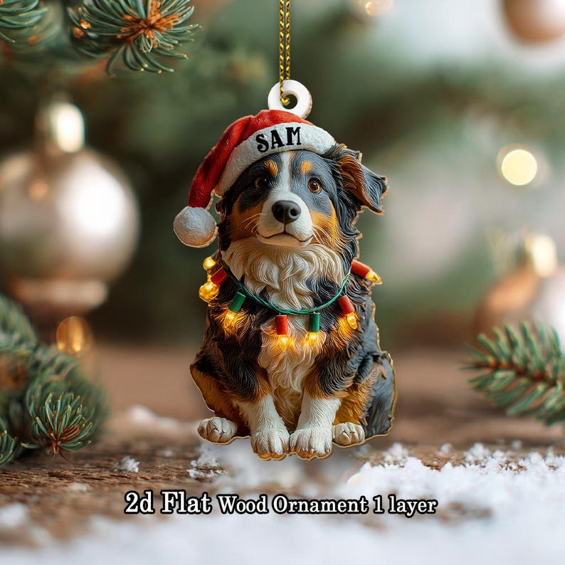 May include: A 2D flat wood ornament featuring a dog wearing a Santa hat with the name "SAM" on it. The dog has a festive light garland around its neck. The ornament is designed for Christmas.
