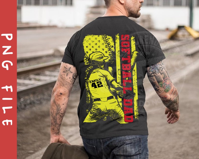 May include: Black t-shirt with a yellow and red graphic design. The graphic features a softball player with the text "Softball Dad" and "Emily 42".