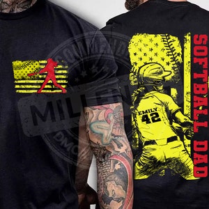 May include: Black t-shirt with a yellow and red softball player graphic on the front and a yellow and red softball player graphic with the text "Softball Dad" on the back.