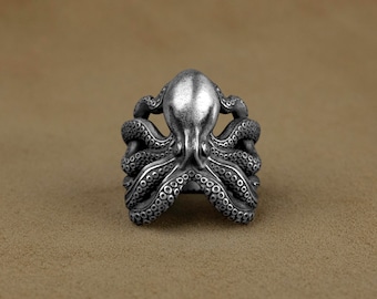 May include: A silver octopus ring with detailed tentacles. The ring is made of metal and has a realistic design.