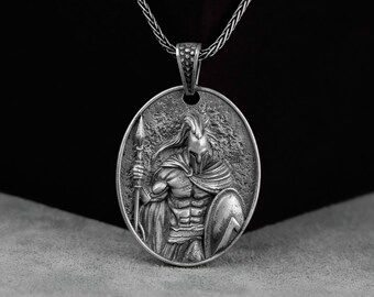 May include: Silver necklace with a round pendant featuring a detailed depiction of a Spartan warrior holding a spear and shield.