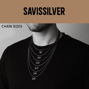 May include: A black t-shirt with a silver chain necklace. The chain is shown in different lengths, from 18 inches to 28 inches.
