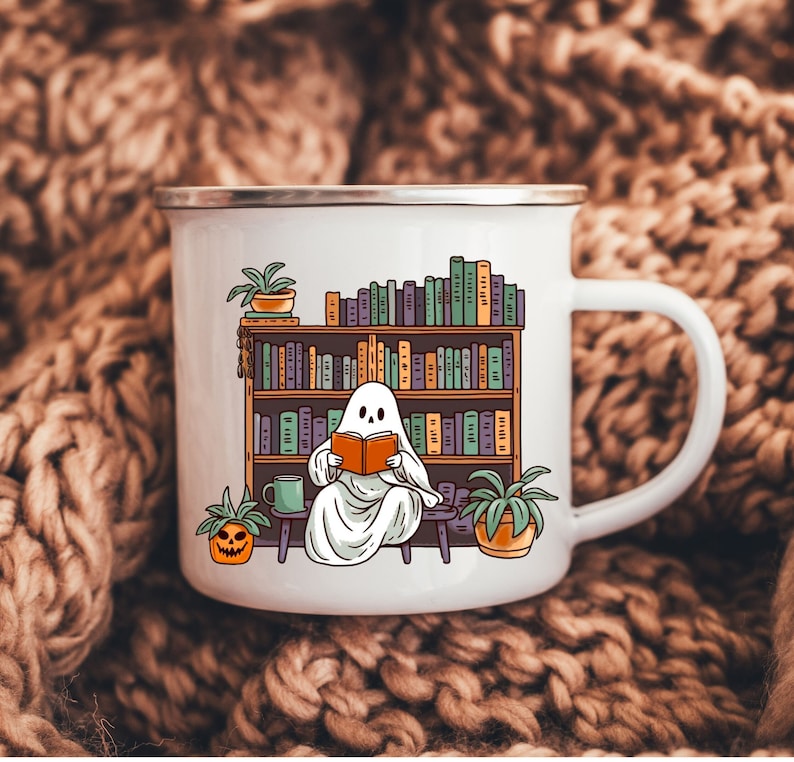white camp enamel mug with silver rim, this ghost mug design has a cottagecore ghost reading a book with bookshelf and coffee mug, perfect gift for book lovers and a great ghost mug for a gothic friend.