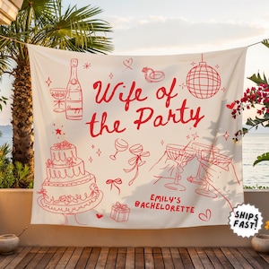Peut inclure: Une banni&egrave;re cr&egrave;me avec des illustrations et du texte en trait rouge. Le texte dit "Wife of the Party" avec "Emily's Bachelorette" en dessous. Les illustrations comprennent une bouteille de champagne, un g&acirc;teau et des verres &agrave; champagne.