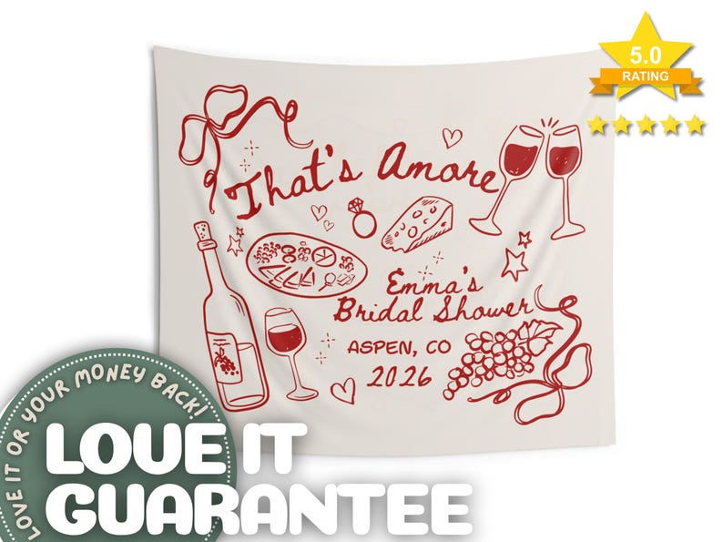 May include: A cream-colored tapestry with red illustrations and text. The design includes wine glasses, a bottle of wine, pizza, cheese, and grapes. Text reads "That's Amore" and "Emma's Bridal Shower, Aspen, CO 2026".