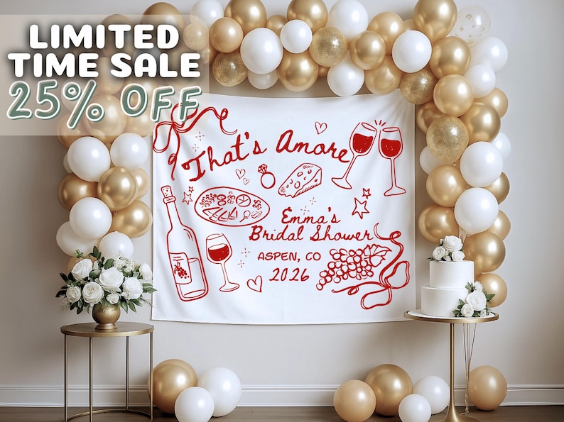 May include: A bridal shower backdrop with a white banner featuring red illustrations of wine, food, and text that reads "That's Amore" and "Emma's Bridal Shower, Aspen, CO 2026." The scene is decorated with gold and white balloons, a cake, and floral arrangements.