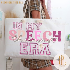 May include: White canvas tote bag with pink and purple text that reads "In My Speech Therapist Era".