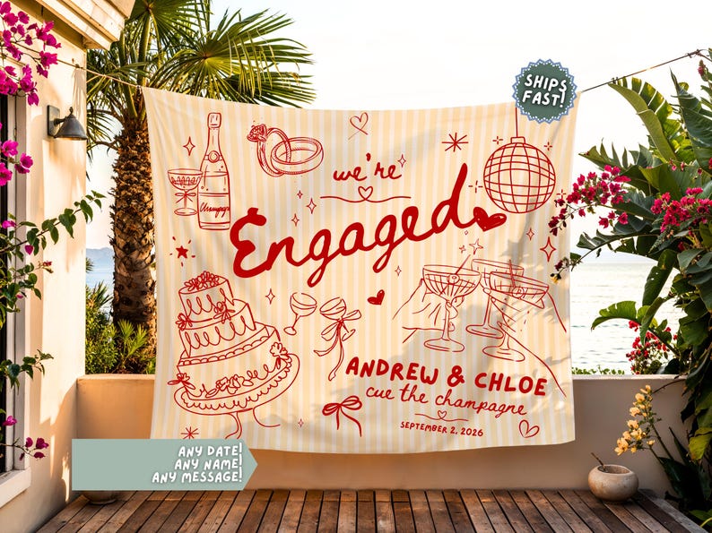 May include: A cream and white striped fabric backdrop featuring red line art illustrations of a champagne bottle, wedding rings, a disco ball, a tiered cake, and cocktail glasses with the text "we're Engaged", "ANDREW & CHLOE", "cue the champagne", and "SEPTEMBER 2, 2026".
