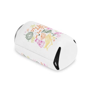 May include: White can cooler with colorful doodle illustrations. The design includes a disco ball, cocktail glass, cake, and text that reads "The sun is setting on her 21st". A black opening is visible on the side.