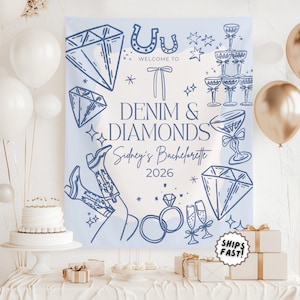 May include: A light blue "Denim & Diamonds" bachelorette party backdrop with diamond, horseshoe, and champagne glass illustrations. The backdrop includes the text "Welcome to Denim & Diamonds Sidney's Bachelorette 2026".