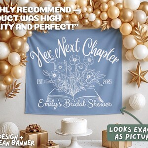 May include: A blue jean banner with white text that reads "Her Next Chapter" and "Emily's Bridal Shower." The banner has a floral design and the year 2025. The banner is part of a bridal shower decoration.