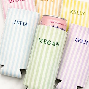May include: A collection of striped drink koozies in pastel colors, each personalized with a name in a coordinating font. One koozie holds a pink can with the text "happy gut, happy life". The koozies are designed to keep beverages cold.