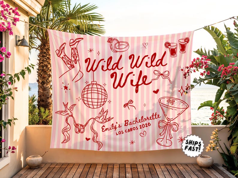 May include: Pink and white striped banner with red illustrations and text. The banner reads "Wild Wild Wife" with additional text "Emily's Bachelorette Los Cabos 2026". Includes images of cowboy boots, a disco ball, and cocktails.