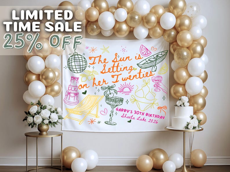 May include: A party backdrop with gold and white balloons, a white banner with colorful illustrations, and a two-tiered cake. The banner reads "The Sun is Setting on her Twenties" and "Gabby's 30th Birthday Shasta Lake 2026."