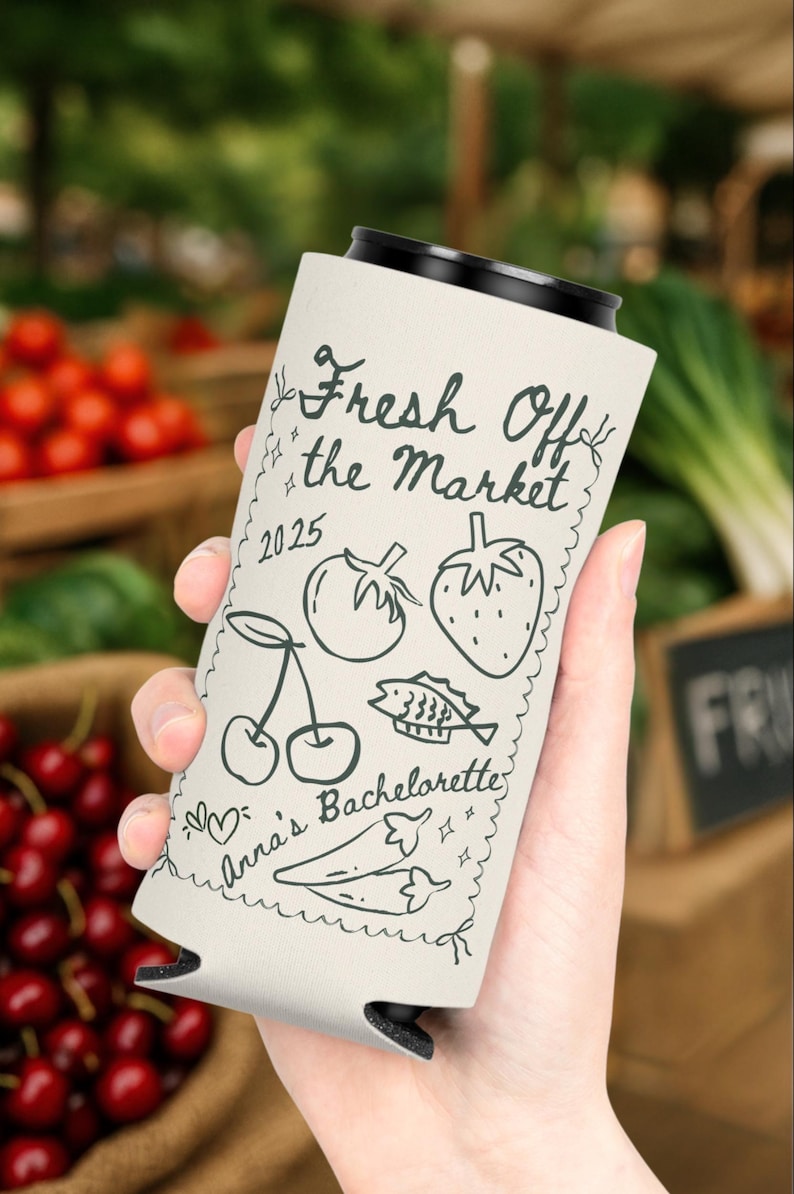 May include: A white can cooler with black trim, featuring the text "Fresh Off the Market" and a series of hand-drawn illustrations including cherries, a tomato, a strawberry, and fish. The text "Anna's Bachelorette" is also included.