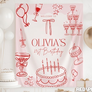 Op de afbeelding: Een roze verjaardagsbanner met rode lijntekeningen van champagneglazen, ballonnen, een taart en de tekst "OLIVIA'S 21st Birthday". Gouden en witte ballonnen staan op de achtergrond.