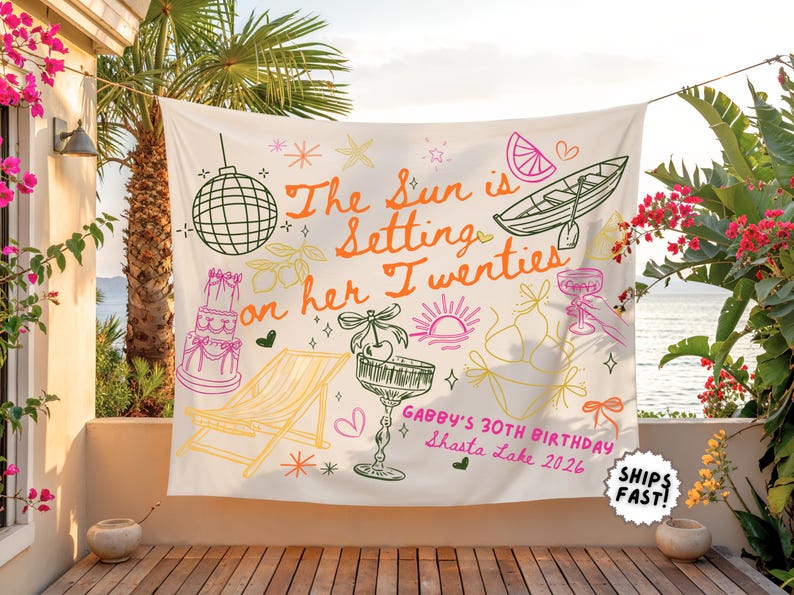 May include: A white tapestry with a hand-drawn design for a 30th birthday celebration. The text "The Sun is Setting on her Twenties" is displayed in orange, with illustrations of a disco ball, cake, and cocktail glass. The text "Gabby's 30th Birthday Shasta Lake 2026" is also included.