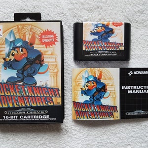 May include: A Sega Genesis game cartridge and instruction manual for Rocket Knight Adventures. The game features a blue and red knight with a rocket pack. The game cartridge is black with a red label and the manual is black with a red and white label.