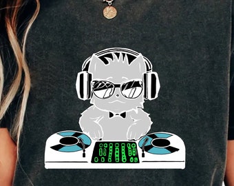 May include: A dark gray t-shirt with a graphic of a cat wearing headphones and sunglasses, holding a DJ mixer.