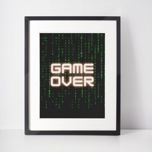 May include: A framed print with a black background and green digital code. The words "GAME OVER" are in white with a glow effect.