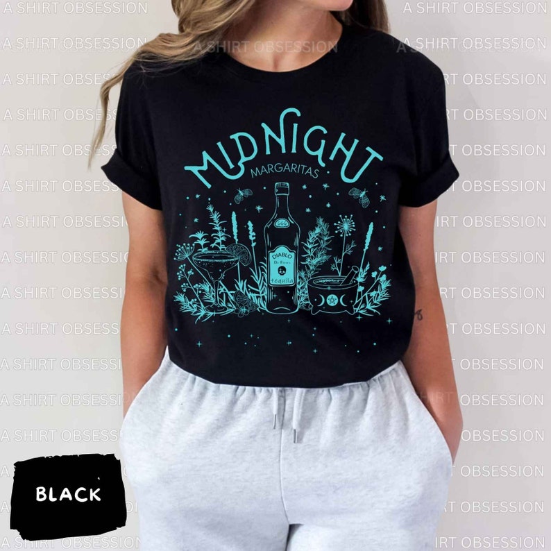 May include: Black t-shirt with a teal graphic design that says "Midnight Margaritas" with a bottle of tequila, a margarita glass, and a cauldron with a crescent moon and stars.