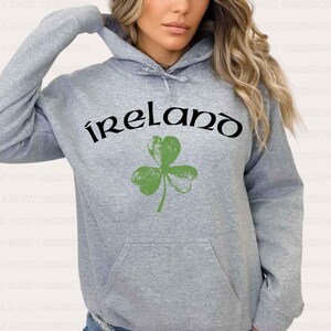 May include: Gray hooded sweatshirt with a green shamrock and the word "ireland" in black lettering.