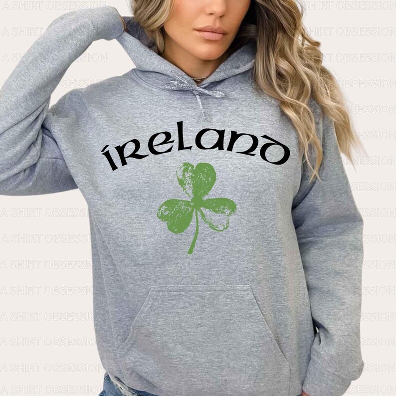 May include: Gray hooded sweatshirt with a green shamrock and the word "ireland" in black lettering.