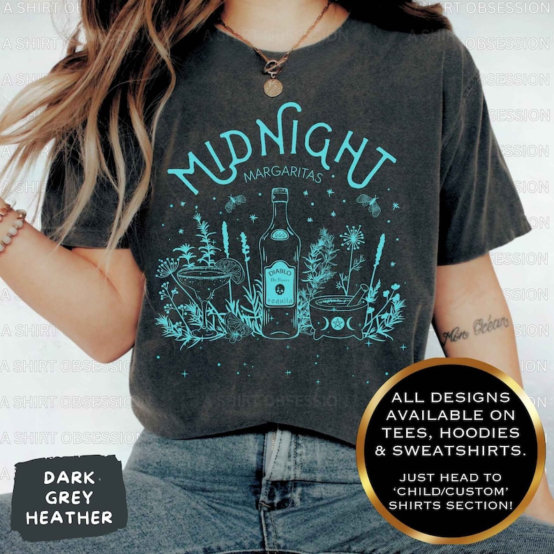 May include: A dark grey heather t-shirt with a teal design of a bottle of tequila, a margarita glass, and a mortar and pestle. The text "Midnight Margaritas" is above the design. The text "All designs available on tees, hoodies & sweatshirts. Just head to 'child/custom' shirts section!" is in the bottom right corner.