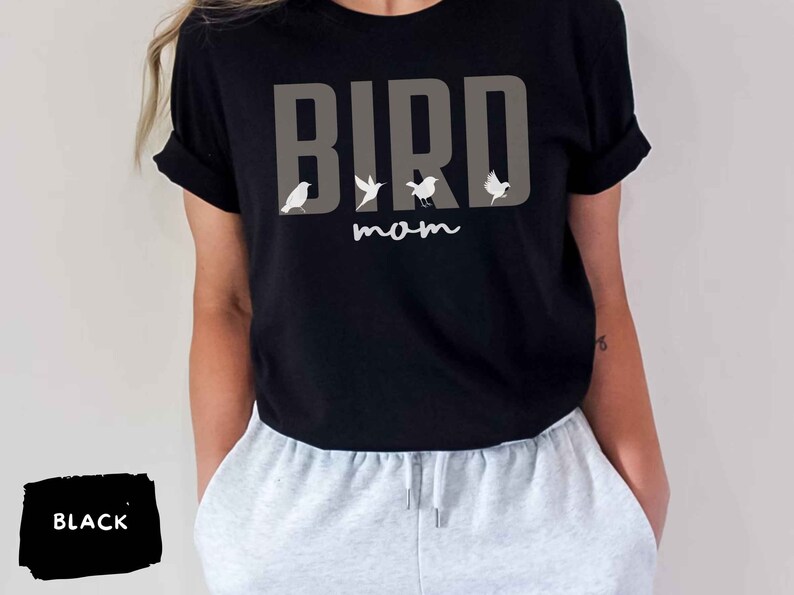 May include: Black t-shirt with the text "BIRD mom" in gray letters and a row of small white birds above the text.