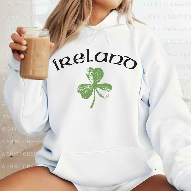May include: White hoodie with a green shamrock and the word "ireland" in black lettering.