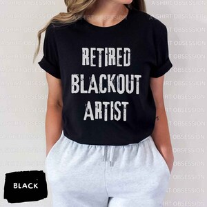 May include: Black t-shirt with white text that reads "Retired Blackout Artist".