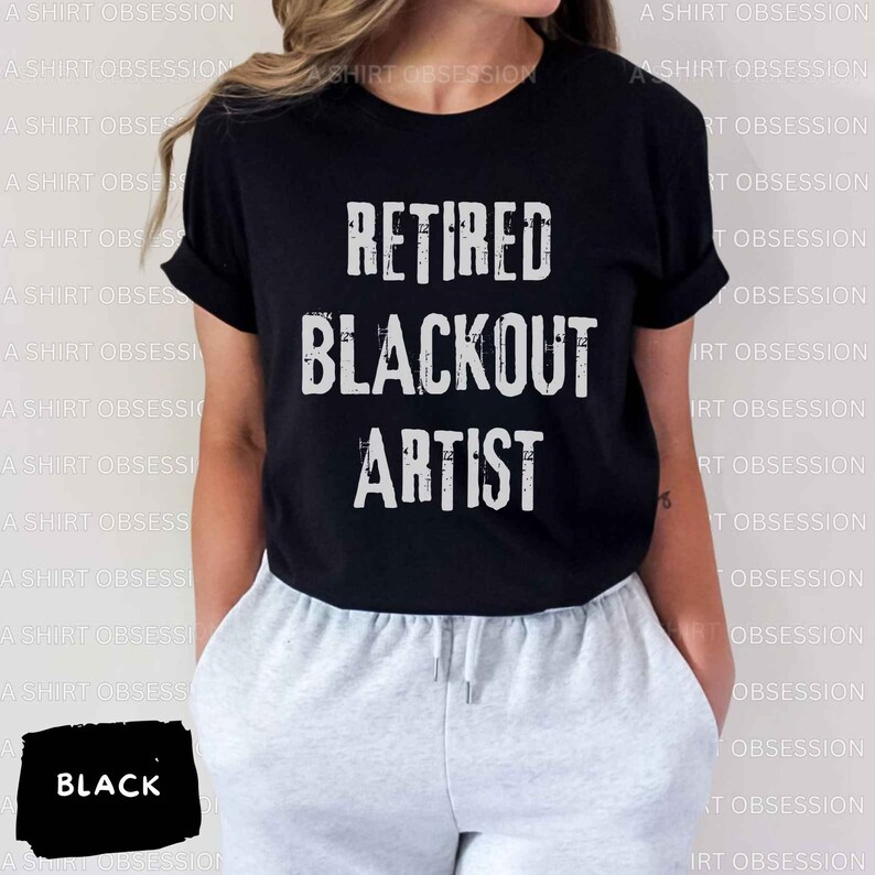 May include: Black t-shirt with white text that reads "Retired Blackout Artist".