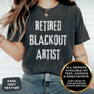 May include: A dark heather grey t-shirt with the text "Retired Blackout Artist" printed in white. The shirt is available in a variety of styles, including tees, hoodies, and sweatshirts. All designs are available in the child/custom shirts section.